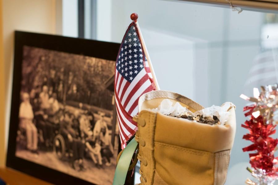 Display in Veterans Resource Center, also home to the Veterans Club, featuring a boot with a plant inside to memorialize female veterans and a photo of older veterans.