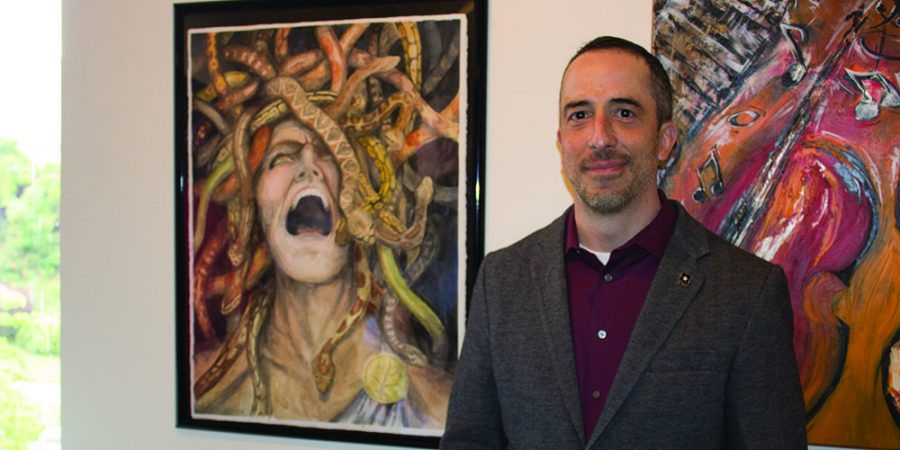 Charles Burt next to his work “Medusa,” displayed at the gallery.