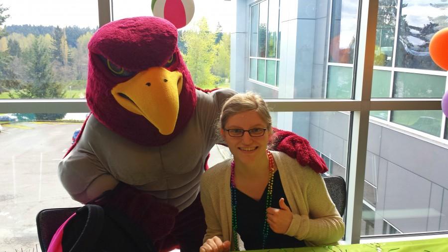 Melissa Stitt-Dastous poses with the Raider Bird while encouraging students to support the Pride Alliance club