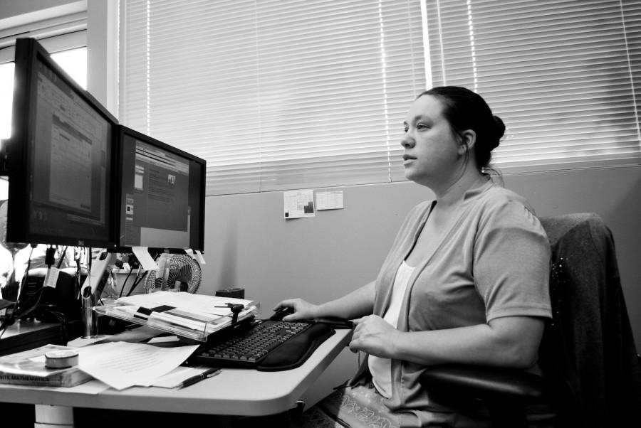 Christina Satterla-Brewer, the TRiO program assistant, runs reports to keep the staff up-to-date on students.