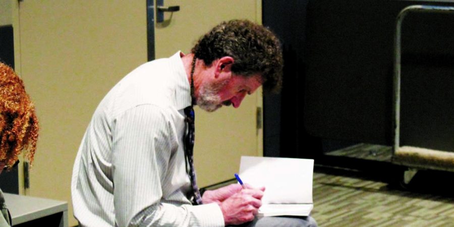 Michael Darcher signing a student’s SLAM copy.