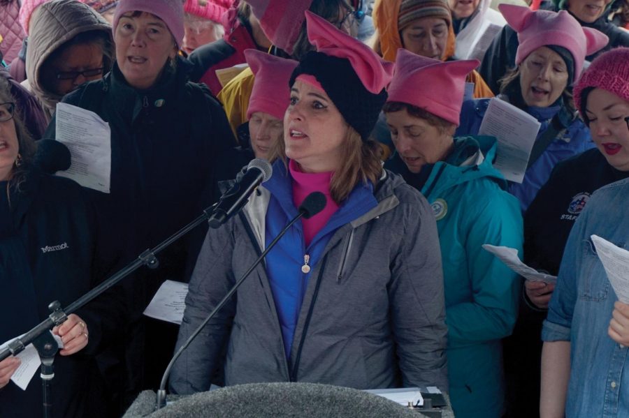 Volunteer singing a song of empowerment and importance to women’s rights