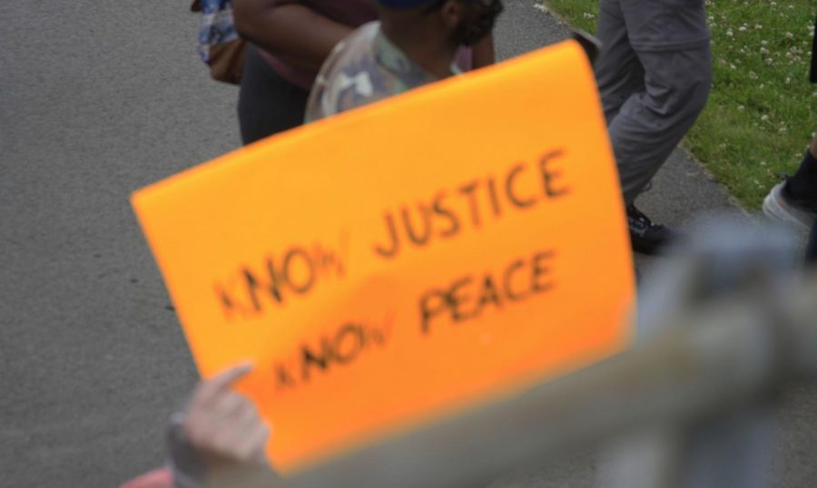 One of the signs stating “know justice, know peace.”
