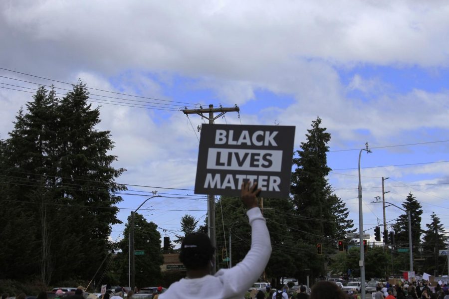 One of the protestors holding a “black lives matter” sign.